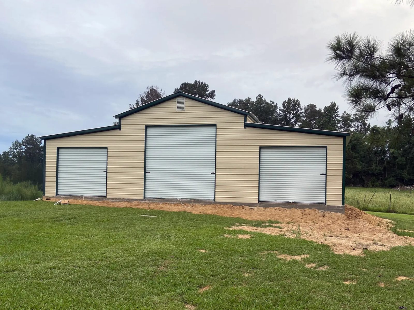 East TX Carports 3 bay barn in pebble beige and forest green