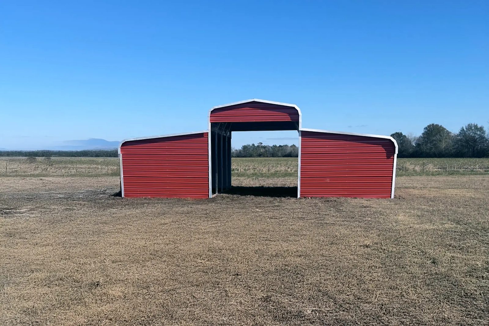 East TX Carports red hay barn in a field