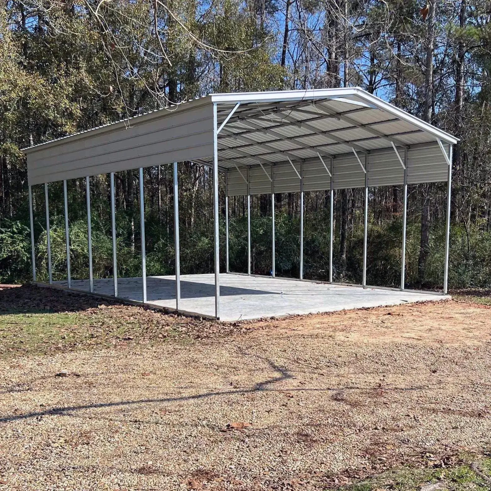 East TX Carports white RV carport in a wooded setting